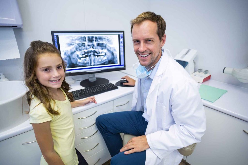 smiling-young-patient-and-dentist-in-dental-clinic-BTFZQMA.jpg