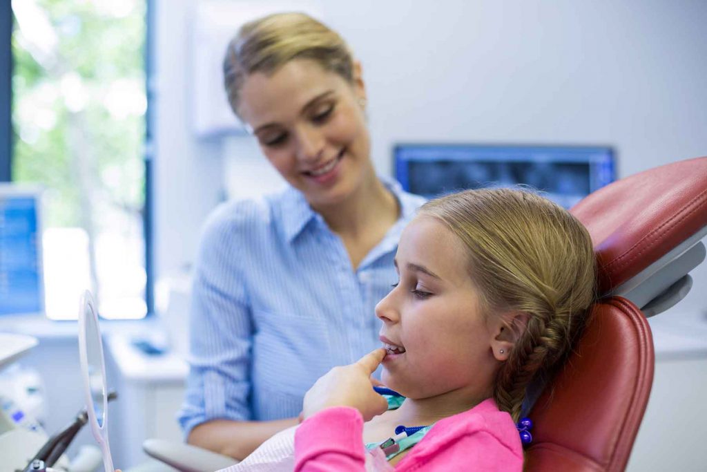 young-patient-looking-in-the-mirror-at-dental-clin-F3JGD5U.jpg